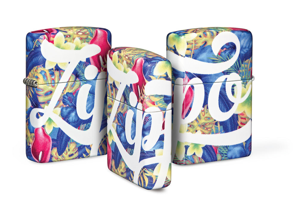 Drei Zippo-Feuerzeuge stehen dekorativ nebeneinander, wobei jedes eine bunte Blumenmusteroptik aufweist, und der Schriftzug "Zippo" in eleganten weißen Buchstaben darauf gedruckt ist.