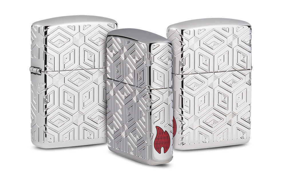 Drei silberne Zippo-Feuerzeuge mit geometrischen Mustern stehen nebeneinander, das mittlere zeigt ein rotes Flammensymbol, während die Umgebung neutral gehalten ist.